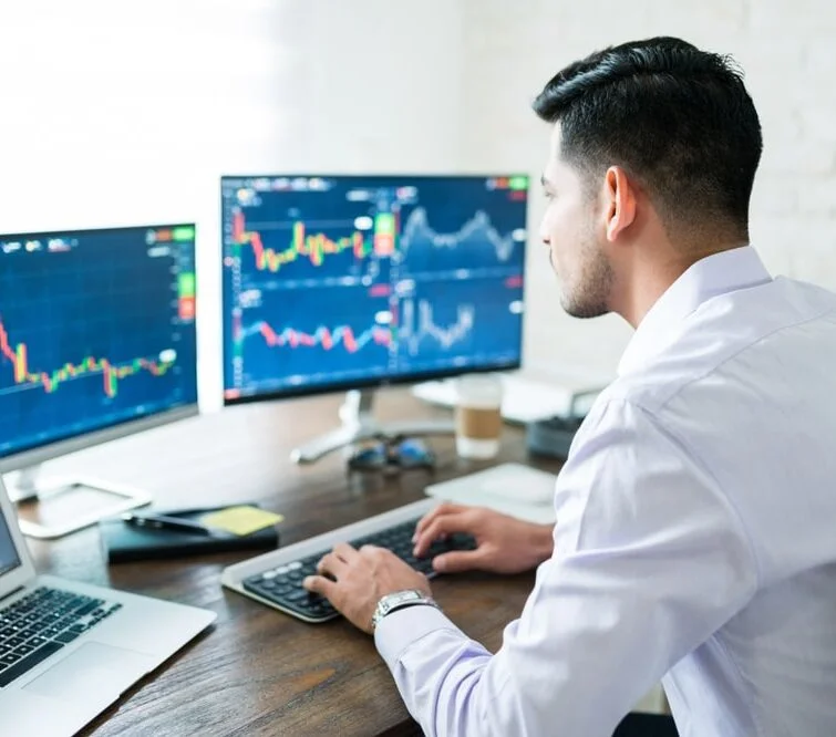 A man at a computer examines graphs